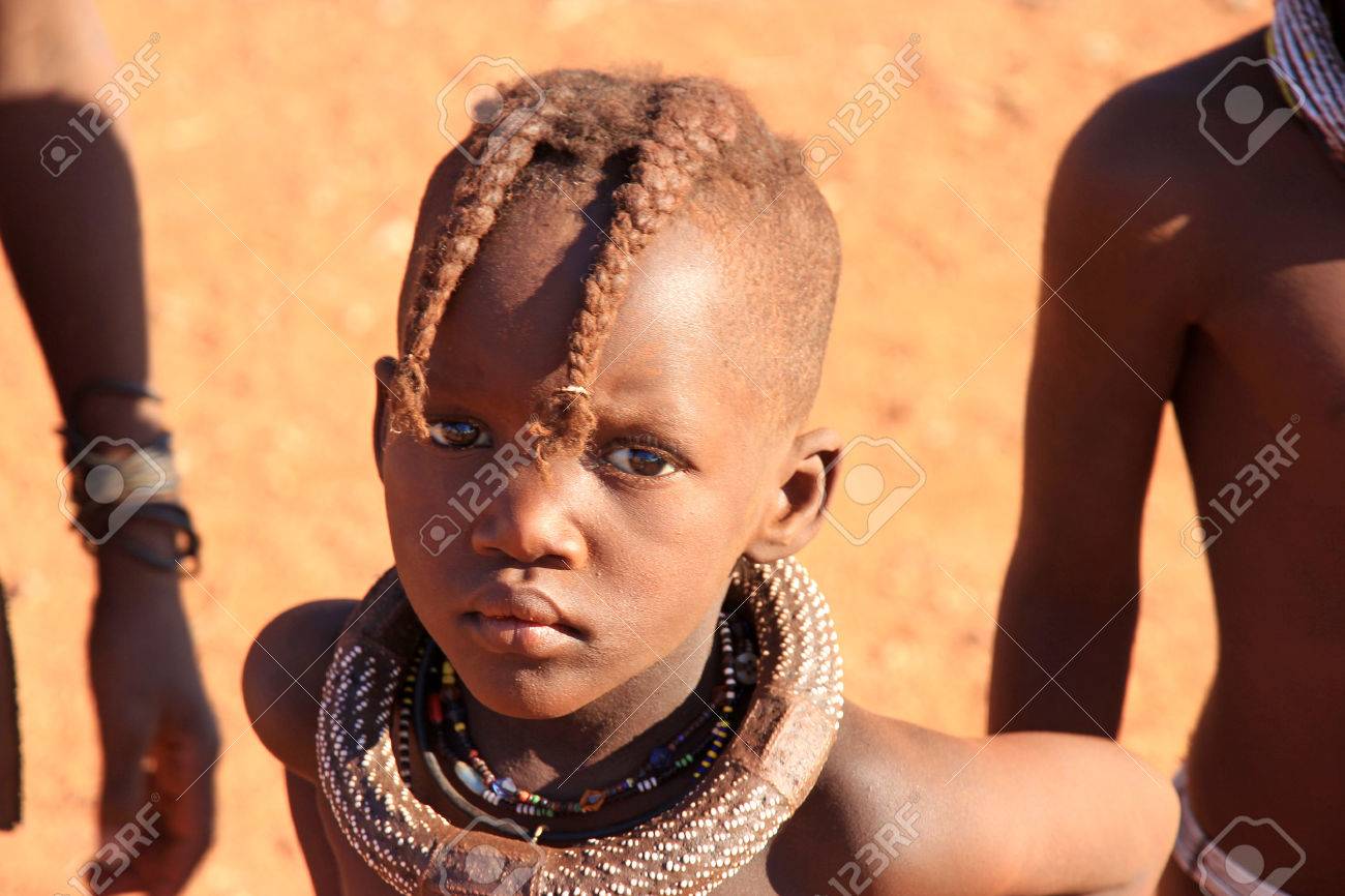 EPUPA, NAMIBIA- MAY 12, 2014: Unidentified Child Himba Tribe. Himba Children Show Their Traditional Clothing, Jewelry EPUPA, NAMIBIA- MAY 12, 2014: Unidentified Child Himba Tribe. Himba Children Show Their Traditional Clothing, Jewelry