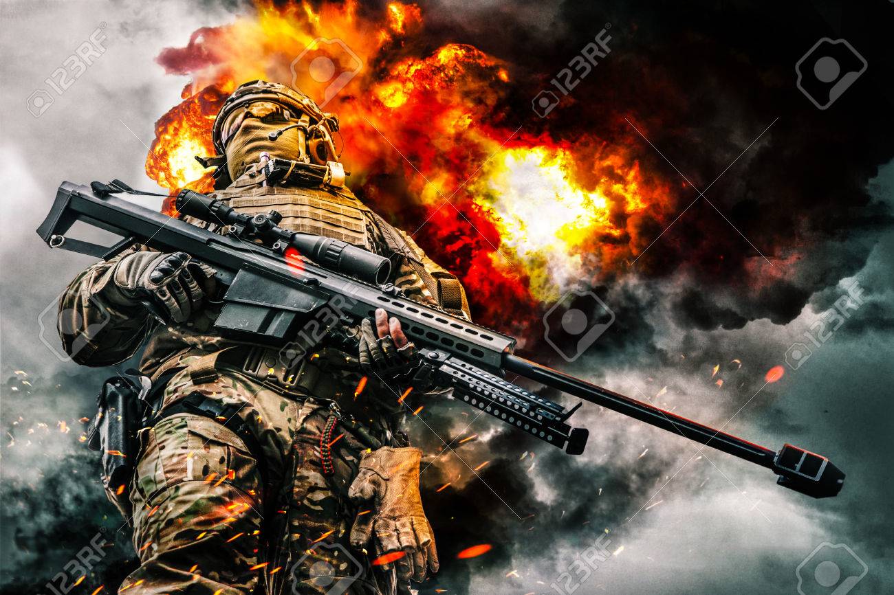 Army sniper of special forces in action posing with large caliber rifle. Heavy explosions, fire and smoke billowing on background. Low angle view - 79145773 Army sniper of special forces in action posing with large caliber rifle. Heavy explosions, fire and smoke billowing on background. Low angle view - 79145773
