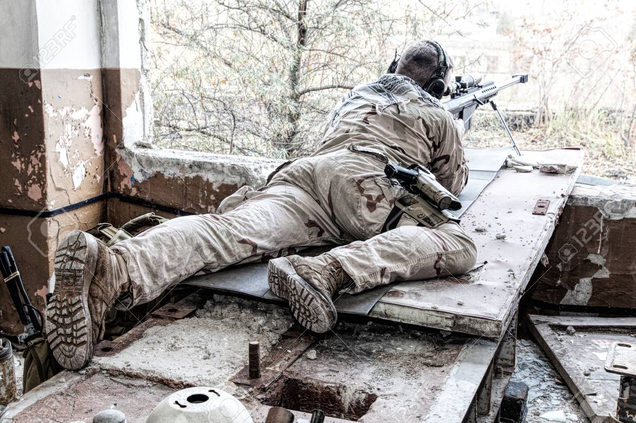 Portrait Of U.S. Navy SEAL Sniper On Firing Position, Armed With Large  Caliber Sniper Rifle With Telescopic Sight, Wearing Tactical Headset With  Microphone, Observing Territory, Searching Targets Stock Photo, Picture and  Royalty, image size:1300x866