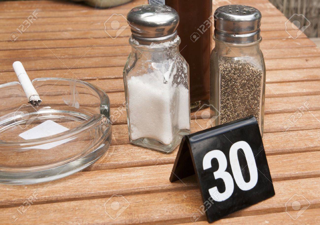 Cafe Table Setting With Salt, Pepper, An Ashtray And Smoking.. Stock ... Cafe Table Setting With Salt, Pepper, An Ashtray And Smoking.. Stock ...