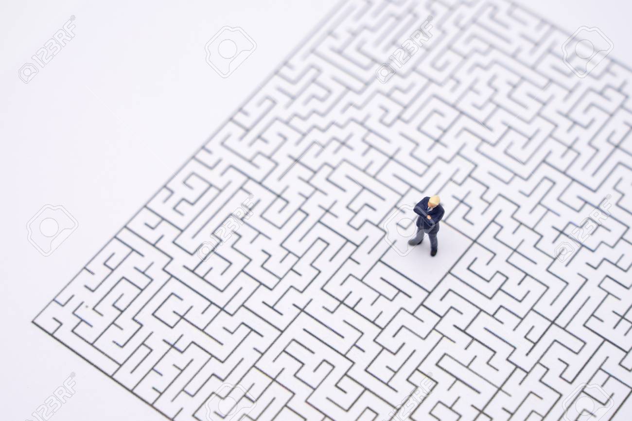 Miniature people businessmen standing in the center of the maze. Business Idea Concepts Troubleshooting Analysis of problems to find solutions. - 119534172 Miniature people businessmen standing in the center of the maze. Business Idea Concepts Troubleshooting Analysis of problems to find solutions. - 119534172