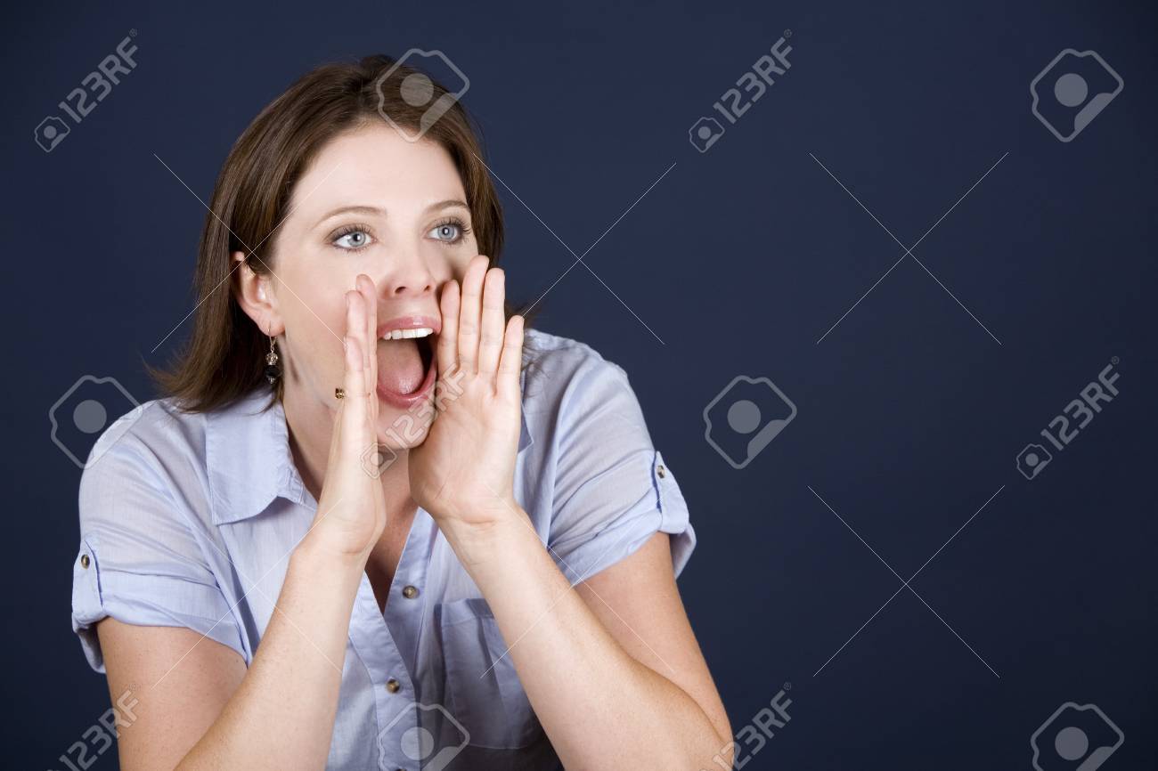 pretty casual brunette screaming on dark background - 10356083 pretty casual brunette screaming on dark background - 10356083