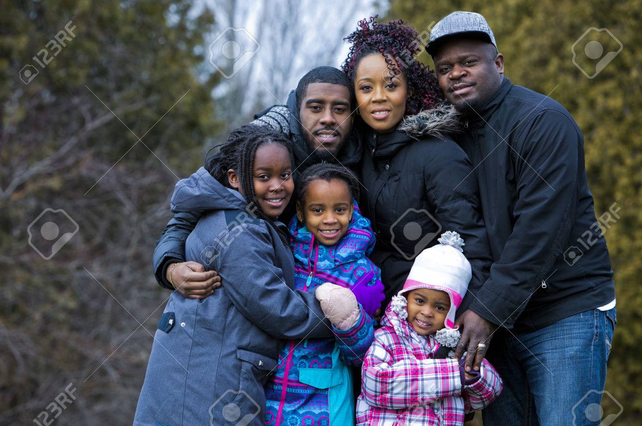 casual winter young black family outdoors in the park - 49698479 casual winter young black family outdoors in the park - 49698479