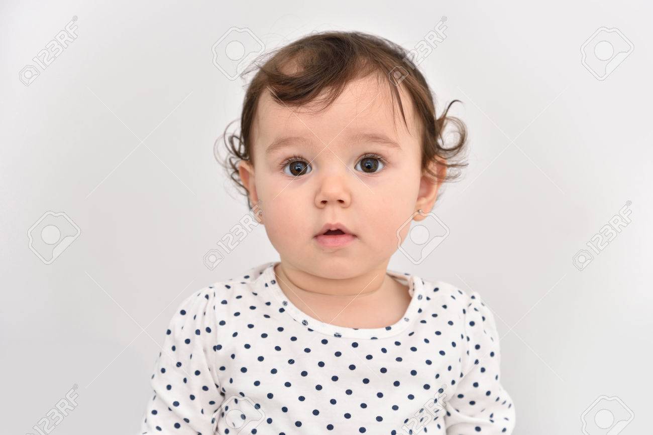 Portrait of a cute baby girl with beautiful big brown eyes. Isolated.. Portrait of a cute baby girl with beautiful big brown eyes. Isolated..