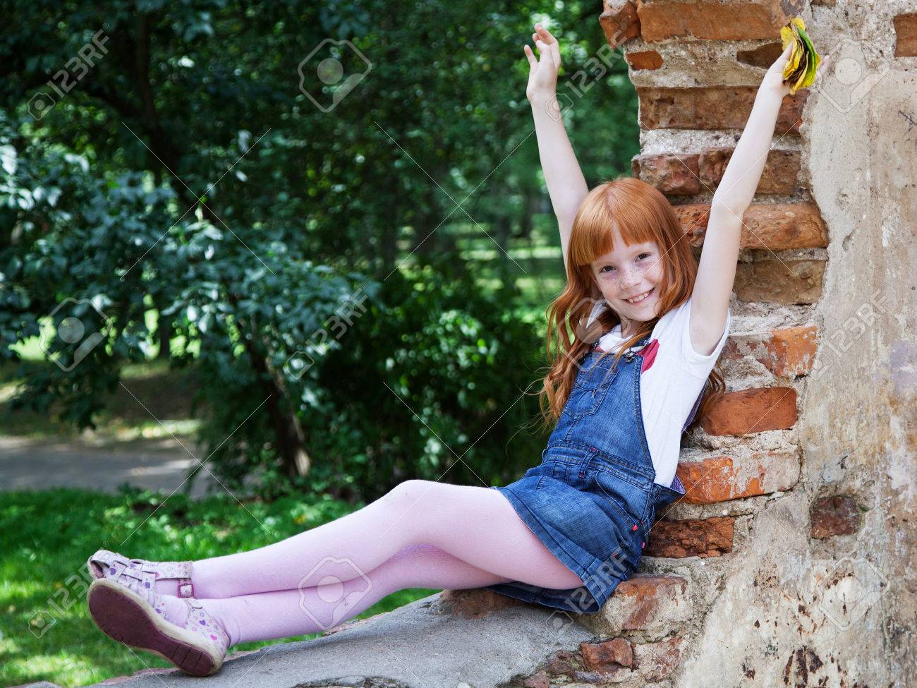 Ginger tiny model Little Ginger Girl Sitting On The Red Brick Wall In The Park Stock Photo,  Picture and Royalty Free Image. Image 62171438.