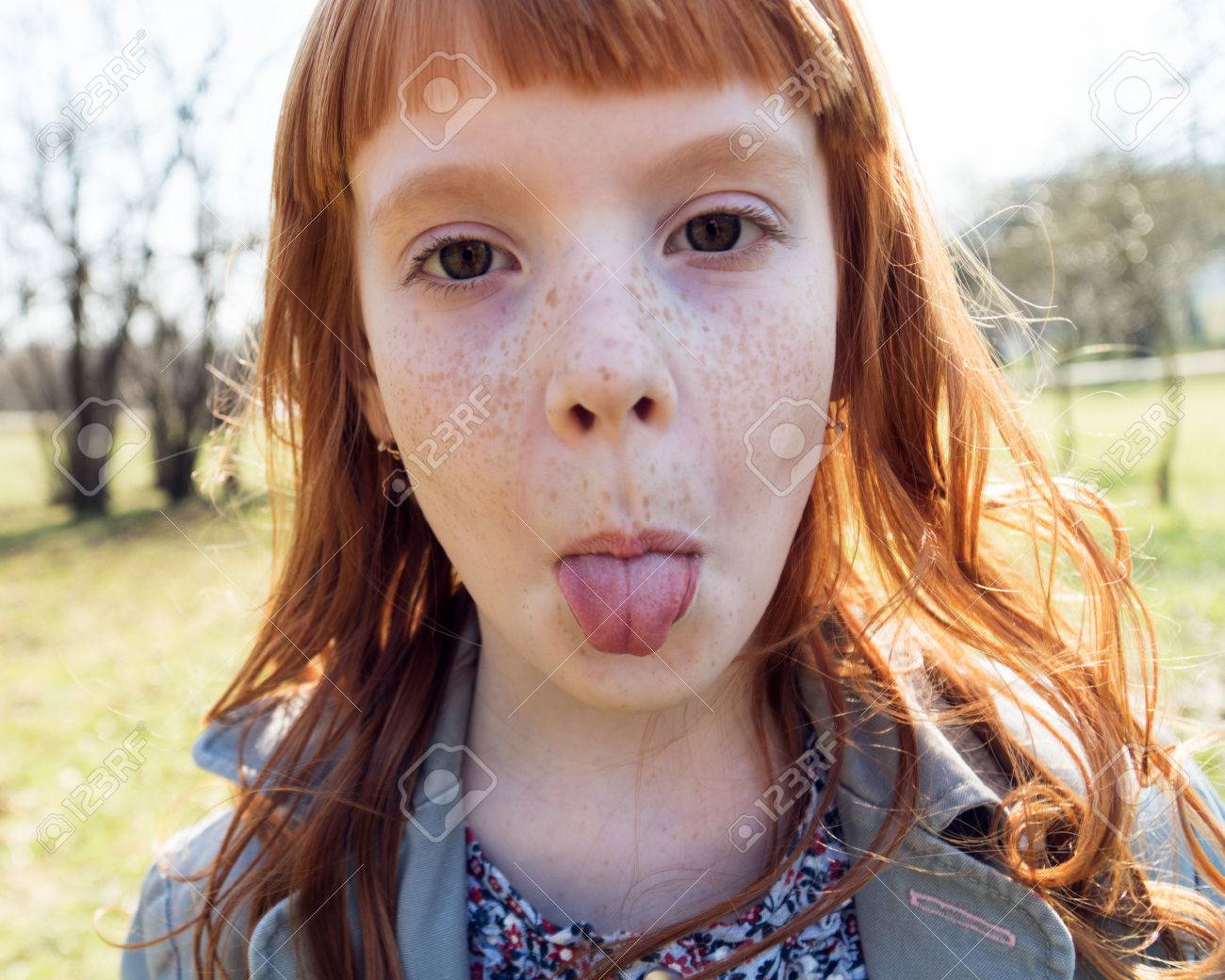 Happy Little Girl Showing Tongue, Close Up Stock Photo, Picture and Royalty  Free Image. Image 80894521., image size:1300x1040