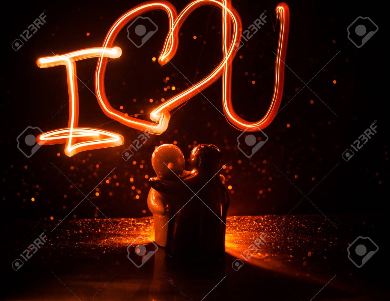 Two Young Lovers Paint A Heart On Fire Silhouette Of Couple