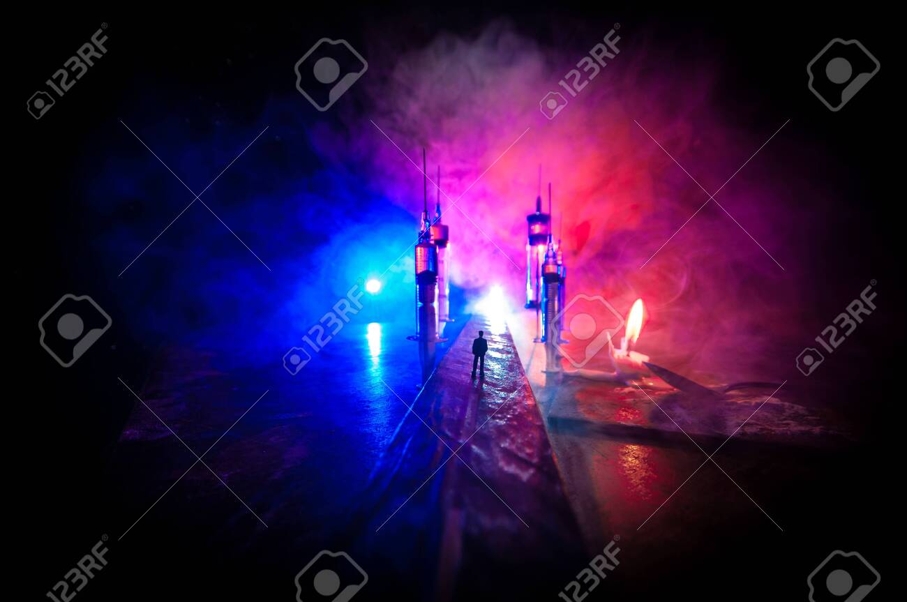 Narcotic drug problem concept. Silhouette of a man standing in the middle of the road on a misty night with giant Drug syringe and narcotic attributes. Creative artwork decoration - 142571851 Narcotic drug problem concept. Silhouette of a man standing in the middle of the road on a misty night with giant Drug syringe and narcotic attributes. Creative artwork decoration - 142571851