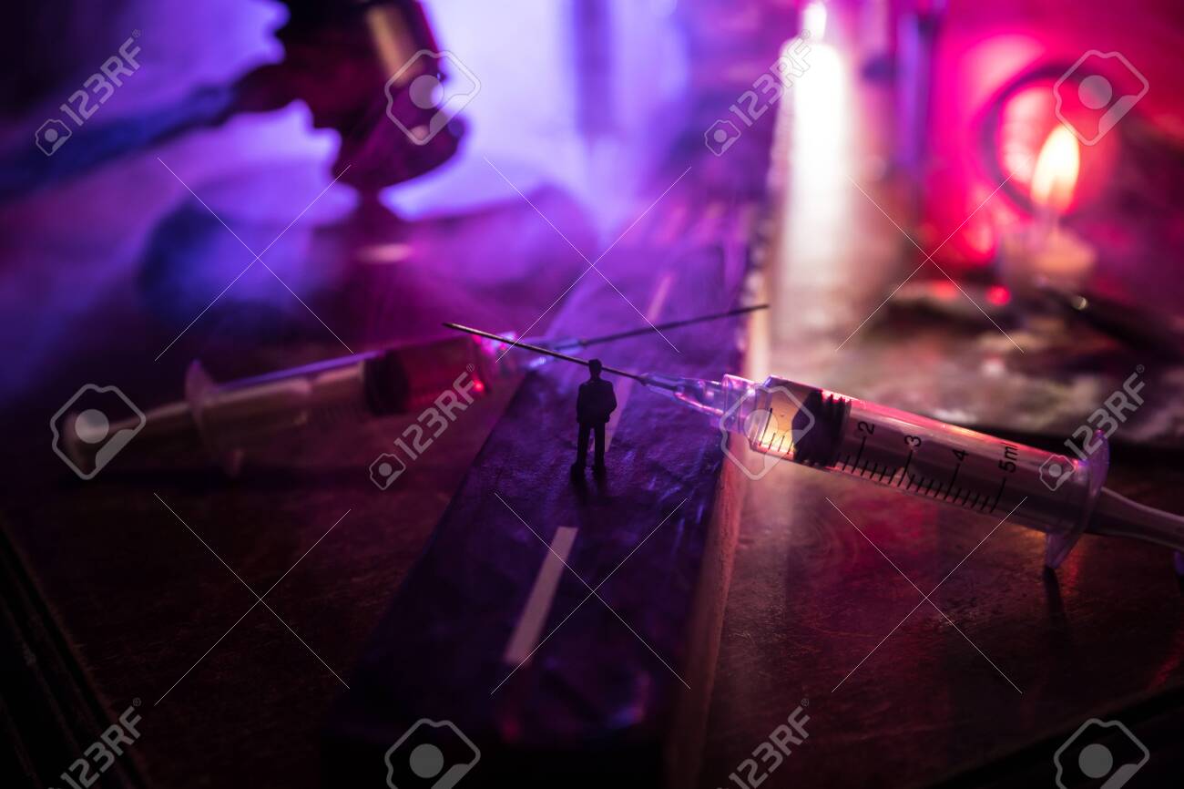 Narcotic drug problem concept. Silhouette of a man standing in the middle of the road on a misty night with giant Drug syringe and narcotic attributes. Creative artwork decoration - 144612533 Narcotic drug problem concept. Silhouette of a man standing in the middle of the road on a misty night with giant Drug syringe and narcotic attributes. Creative artwork decoration - 144612533