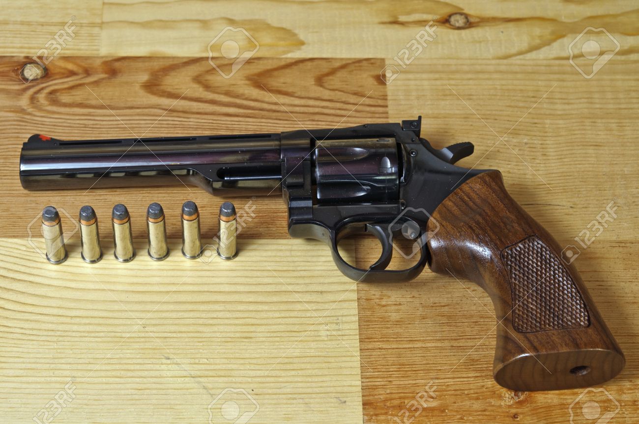 357 Magnum revolver with bullets on wood background Stock Photo - 11645221