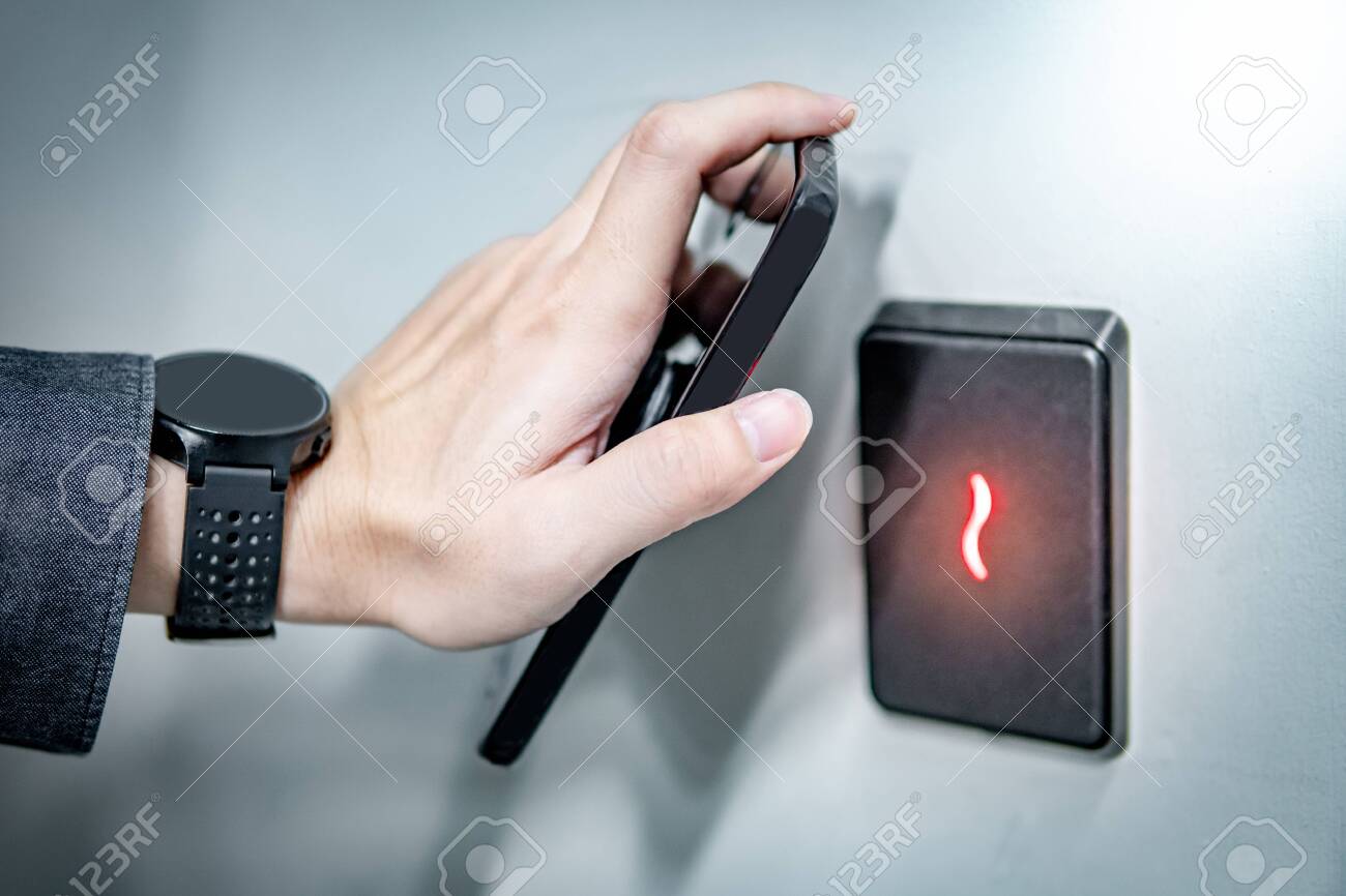 Male hand using smartphone for sensor scanning. Infrared sensor technology for automatic door access and security. - 127828857 Male hand using smartphone for sensor scanning. Infrared sensor technology for automatic door access and security. - 127828857