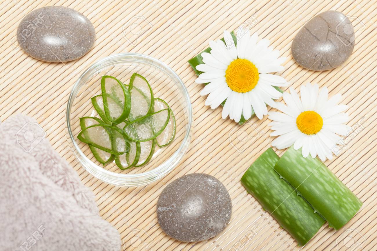 Fresh Aloe Vera, Chamomile Flowers, Sea Stones And A Towel On Bamboo  Background - Upper Viewpoint. Spa And Natural Bodycare Concept Stock Photo,  Picture and Royalty Free Image. Image 86642213.