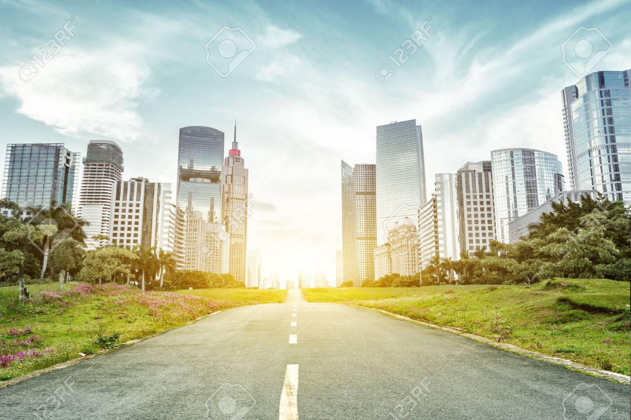 empty asphalt road with trees aside and skyscrapers under sunbeam - 45530633 empty asphalt road with trees aside and skyscrapers under sunbeam - 45530633