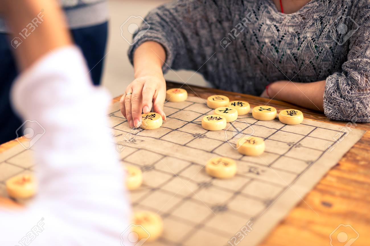 People Playing Chinese Chess In Park 