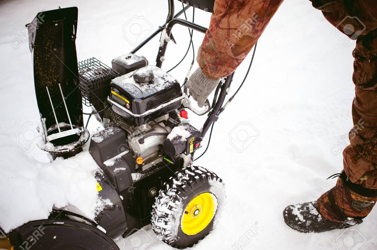 man starts the engine snow blower - 70182841 man starts the engine snow blower - 70182841