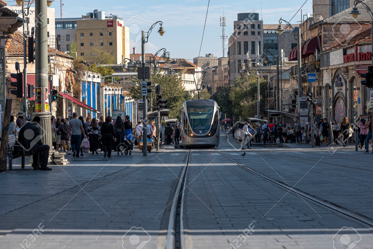 JERUSALEM, ISRAEL, 11/13/2020. Tramway in the city center, new technology transportation with pedestrians on the street. - 161814685 JERUSALEM, ISRAEL, 11/13/2020. Tramway in the city center, new technology transportation with pedestrians on the street. - 161814685