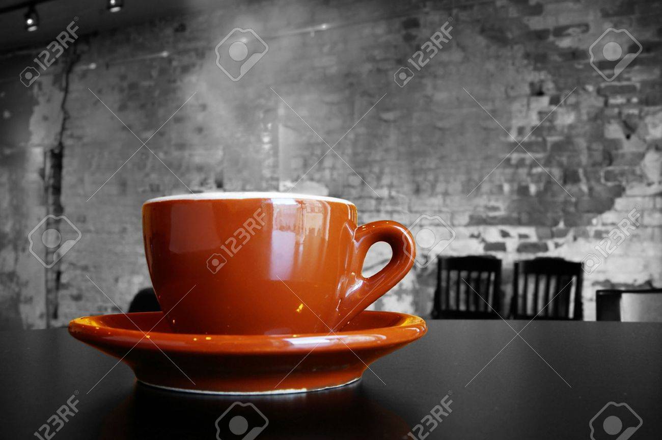 cappuccino coffee cup and saucer in a brick cafe interior stock cappuccino coffee cup and saucer in a brick cafe interior stock