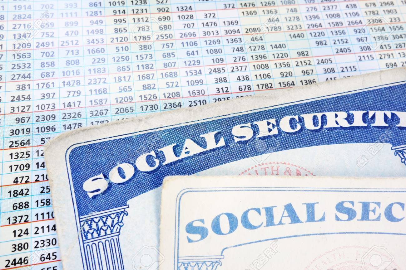 Social Security cards and a sheet of budget numbers - 26082952 Social Security cards and a sheet of budget numbers - 26082952