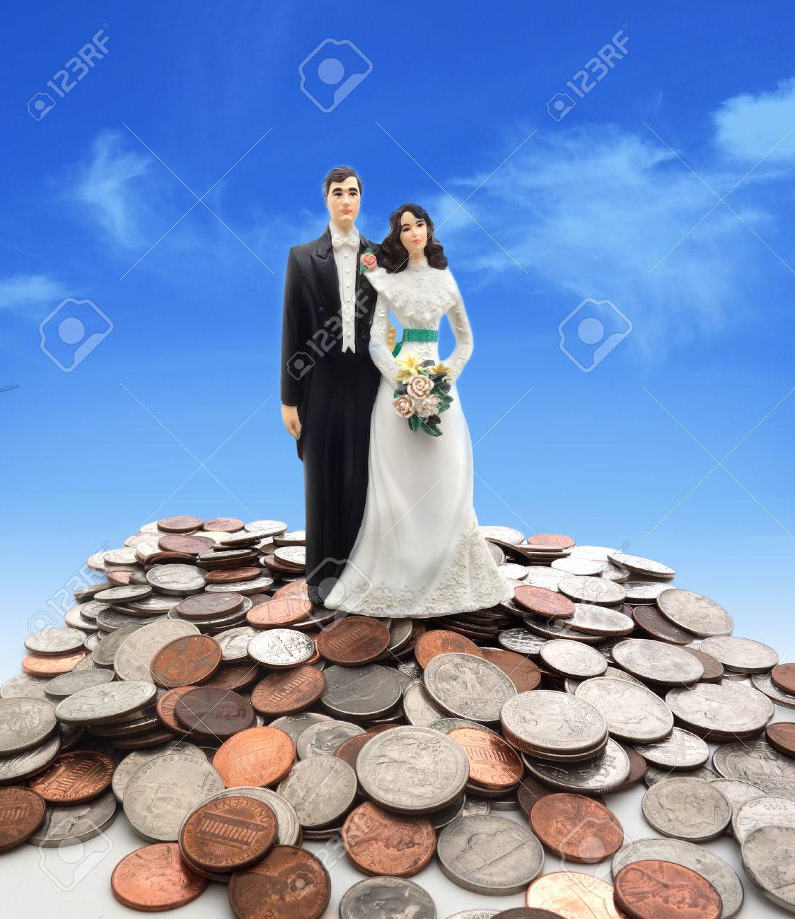Plastic wedding couple on coins - money concept - 33705255 Plastic wedding couple on coins - money concept - 33705255