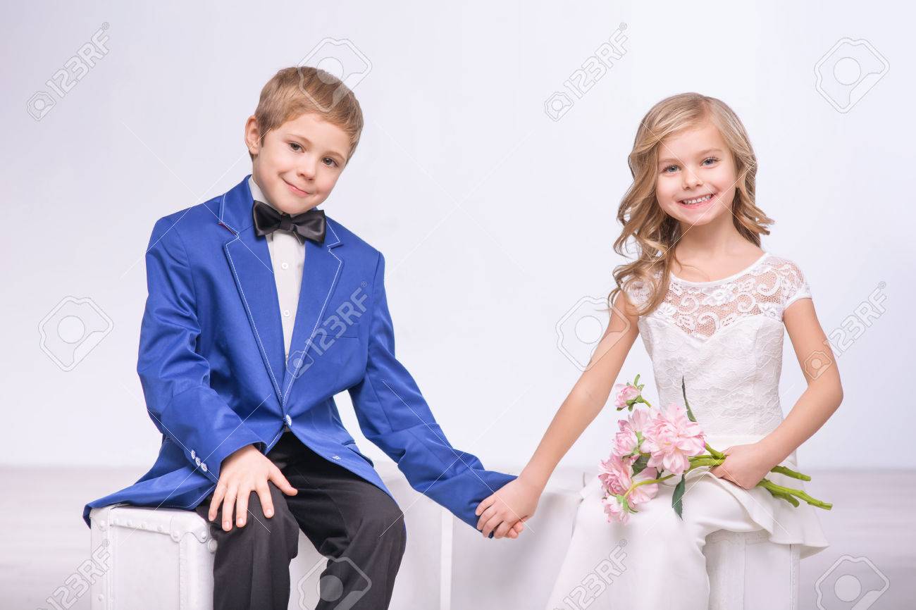 Happy Moment. Pleasant Loving Little Boy And Girl Holding Hands Of Each  Other And Expressing Positivity While Celebrating Wedding Stock Photo,  Picture and Royalty Free Image. Image 51205195., image size:1300x866