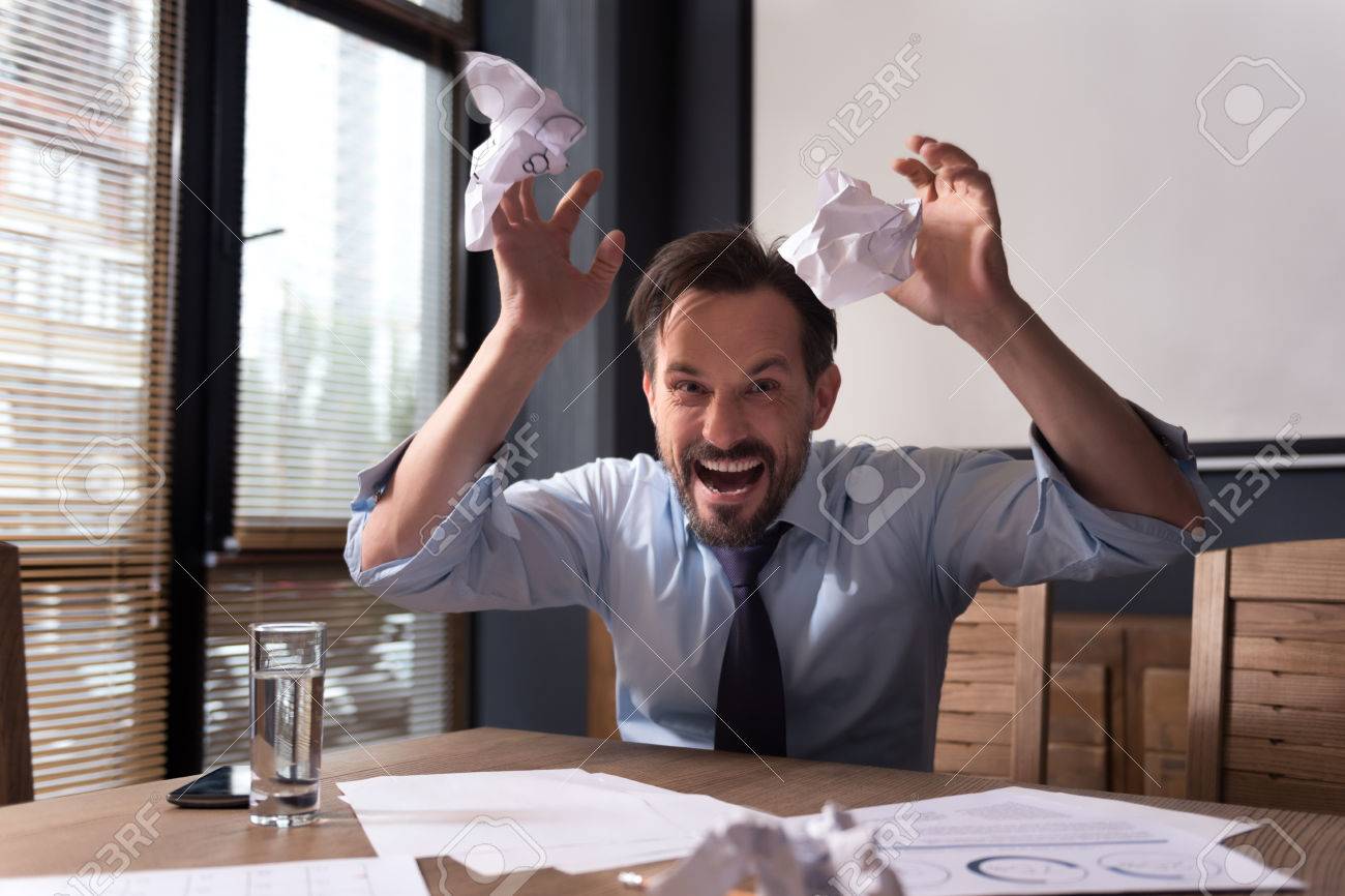 Nervous Breakdown. Hysterical Frantic Angry Man Throwing Crumpled Paper  Around And Grimacing While Threatening You Stock Photo, Picture and Royalty  Free Image. Image 65645488.