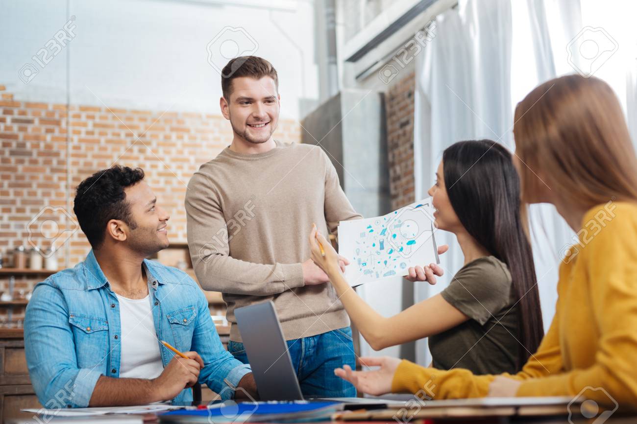 Enthusiastic Students. Smart Positive Young People Feeling Glad While  Looking At Their Fellow Student Standing And Presenting His Interesting  Project Stock Photo, Picture and Royalty Free Image. Image 93227054., image size:1300x866