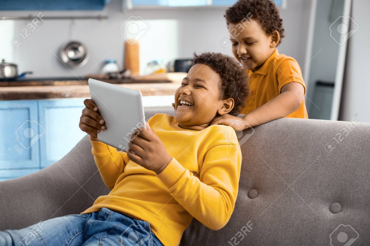 Loving Little Boy Giving His Elder Brother Massage While The Elder Boy Sitting Loving Little Boy Giving His Elder Brother Massage While The Elder Boy Sitting