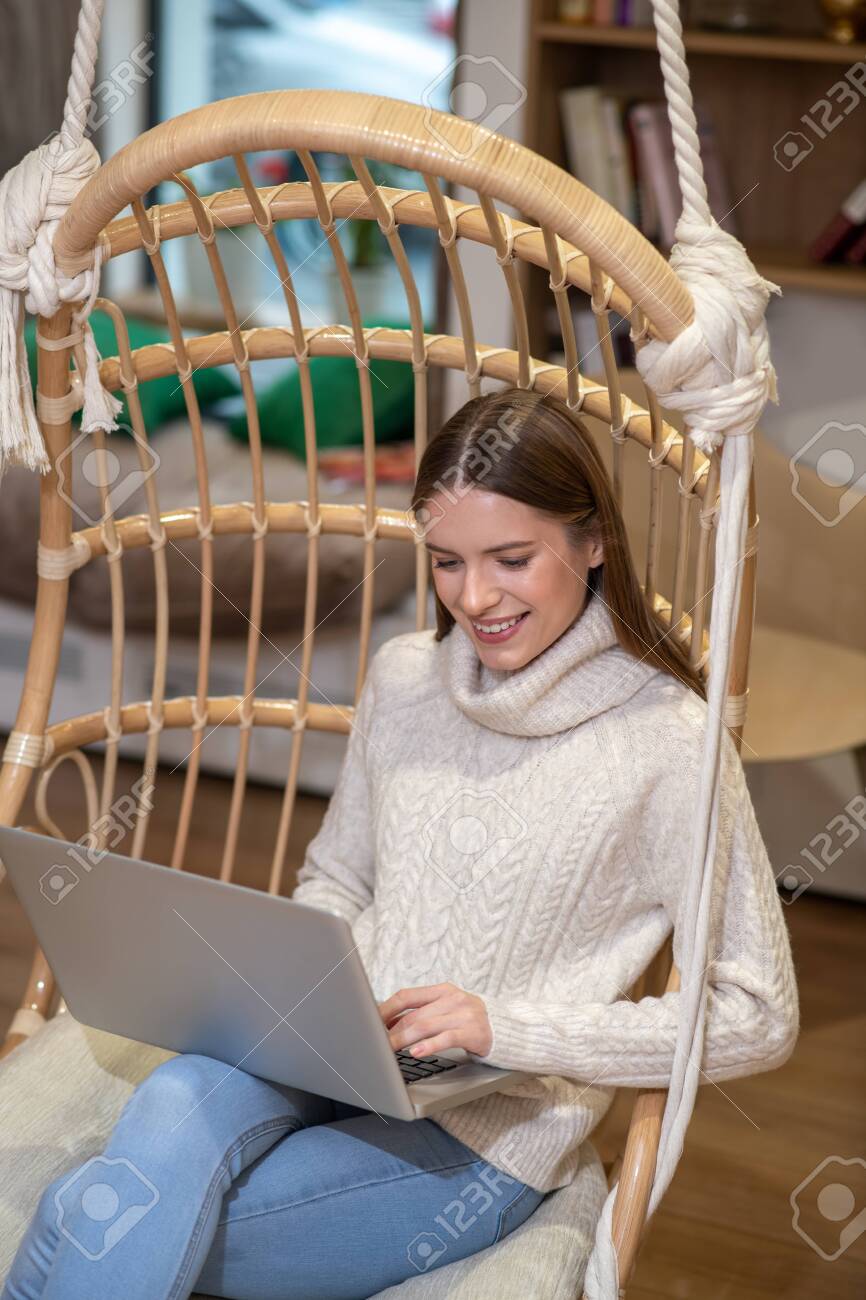 Doing important work. A concentrated woman using her laptop while working - 137174246 Doing important work. A concentrated woman using her laptop while working - 137174246