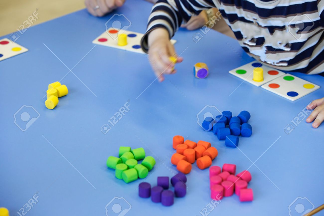 Children playing with homemade, do-it-yourself educational toys, arranging and sorting colors. Learning through experience concept, intelligence development, educational approach concept. - 57972727 Children playing with homemade, do-it-yourself educational toys, arranging and sorting colors. Learning through experience concept, intelligence development, educational approach concept. - 57972727
