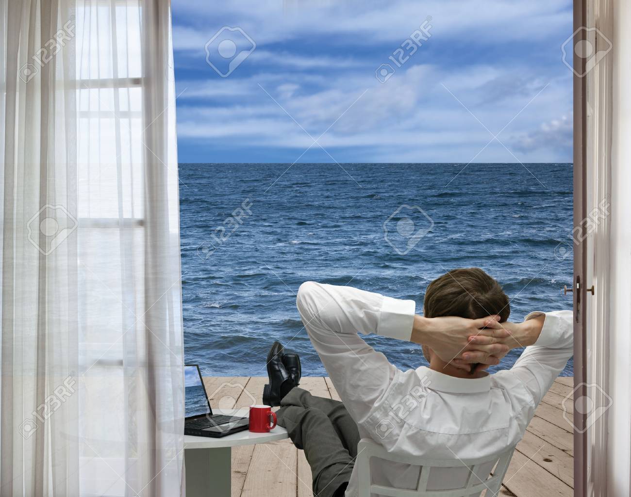 Businessman Relaxing On The Terrace By The Sea Stock Photo Picture And Royalty Free Image Image