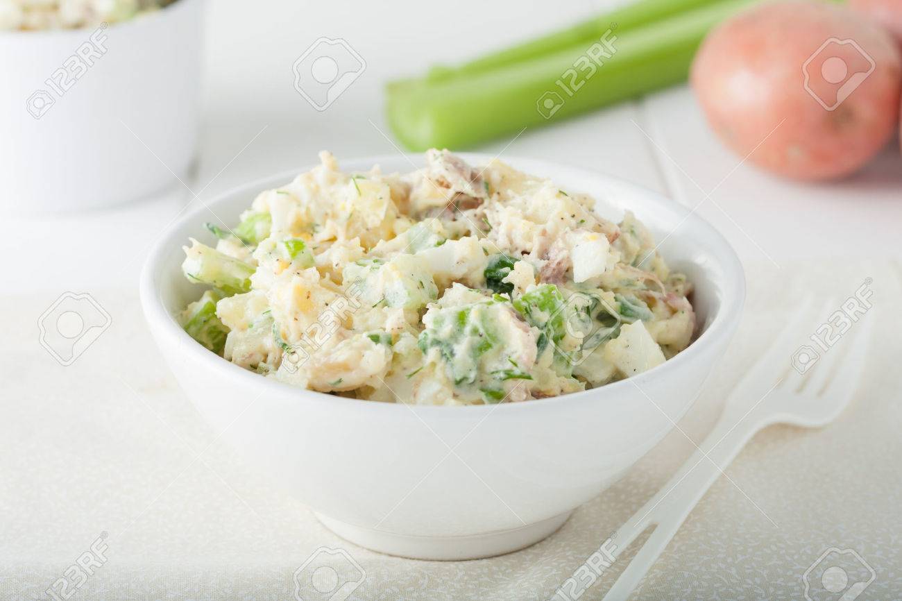 Homemade potato salad Ingredients include celery sticks and herbs in white bowl - 37604378 Homemade potato salad Ingredients include celery sticks and herbs in white bowl - 37604378