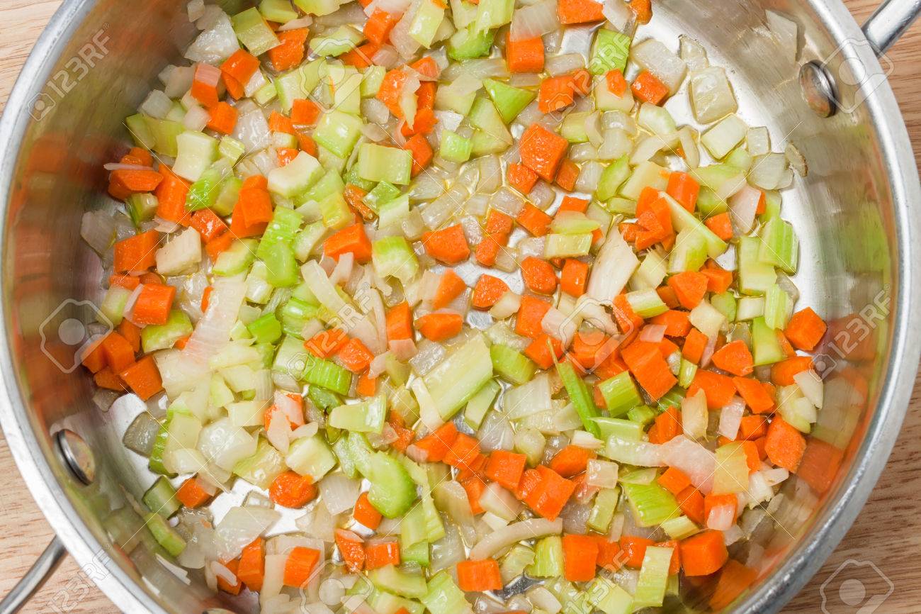 chopped soup ingredients: carrots, onions and celery cooking in a stainless steel pot - 38979442 chopped soup ingredients: carrots, onions and celery cooking in a stainless steel pot - 38979442