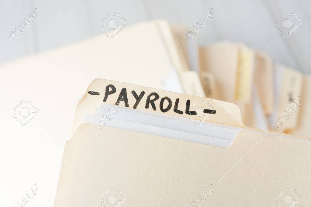 yellow paper folder labeled PAYROLL containing employee information of a small business firm - 38981554 yellow paper folder labeled PAYROLL containing employee information of a small business firm - 38981554