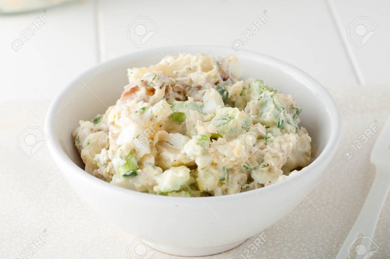 close up of homemade potato salad made with red potatoes, celery sticks, red onions and fresh herbs in white bowl - 47320588 close up of homemade potato salad made with red potatoes, celery sticks, red onions and fresh herbs in white bowl - 47320588
