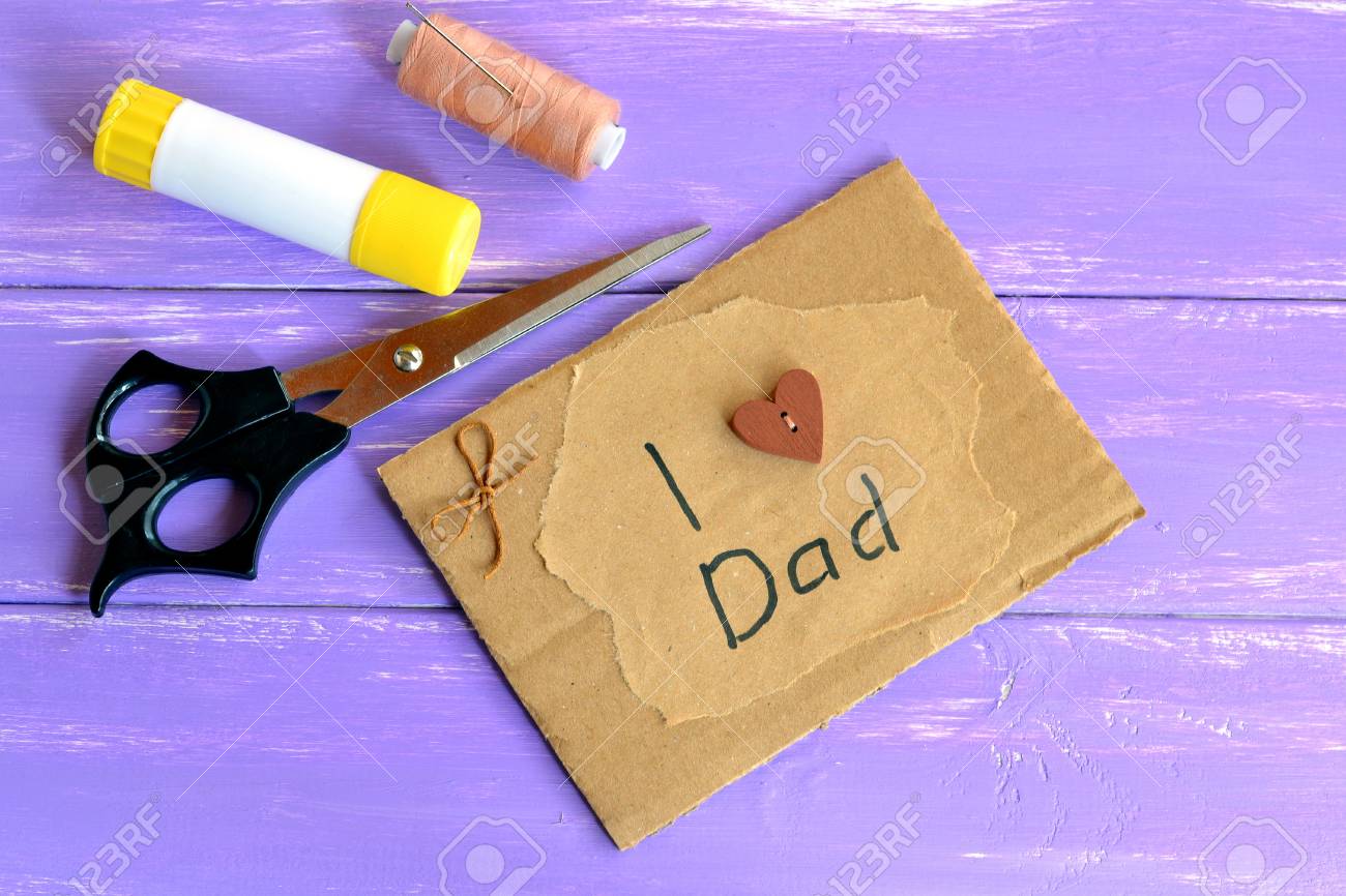 お父さんを大好きグリーティング カード本文です 手作りの父の日カード はさみ スティック ベージュの糸 針を接着します ペーパー クラフトの インスピレーション 子供のための創造的なアイデア 紫の木製の背景 の写真素材 画像素材 Image