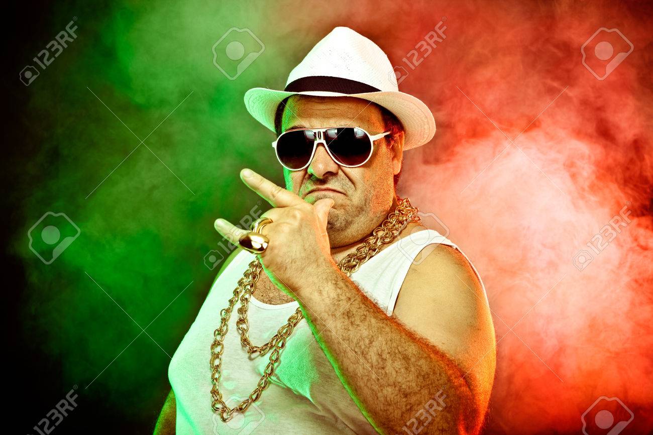 italian funny mafia boss rapper with undershirt and sunglasses on smoky background - 57209424
