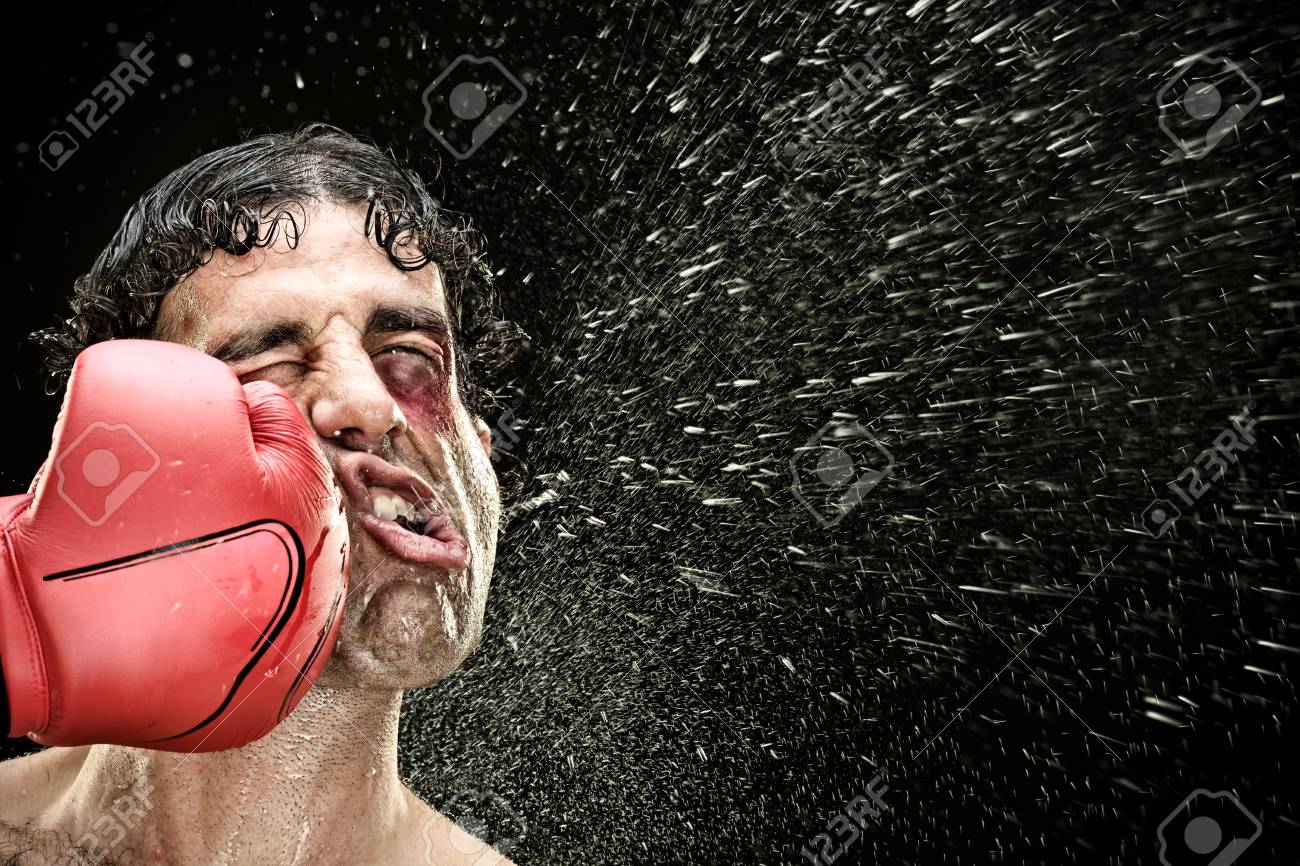 95689415-silly-boxer-man-takes-a-punch-in-the-face-isolated-on-black-funny-concept-portrait.jpg