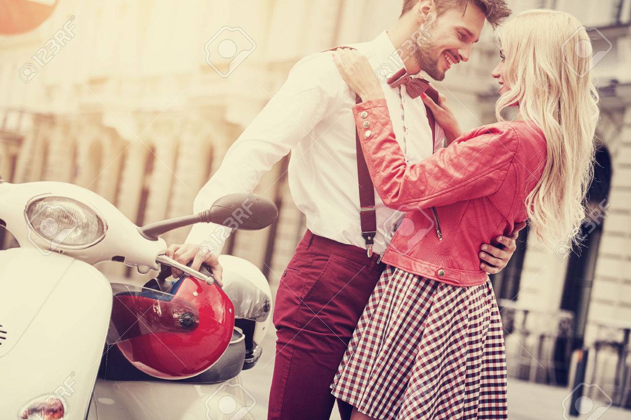 Young couple kissing each other on the street - 49937379 Young couple kissing each other on the street - 49937379