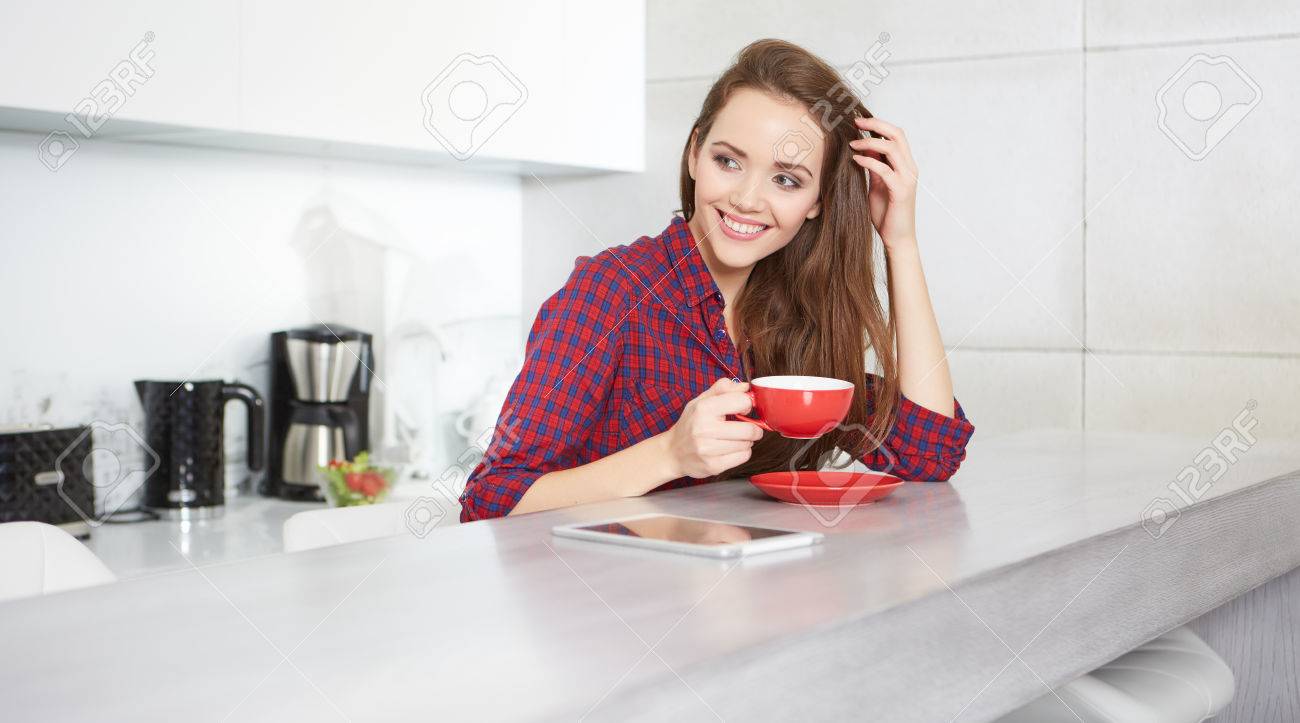 young woman drinking coffee at home in the morning - 50876274 young woman drinking coffee at home in the morning - 50876274