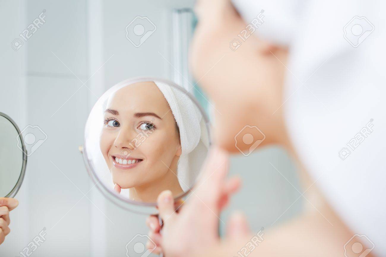 face of young beautiful healthy woman and reflection in the mirror - 51686400 face of young beautiful healthy woman and reflection in the mirror - 51686400