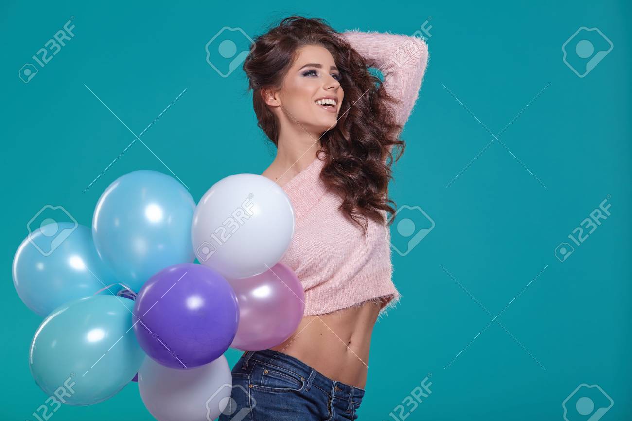 Young pretty woman with colored balloons, turquoise background - 51590633 Young pretty woman with colored balloons, turquoise background - 51590633