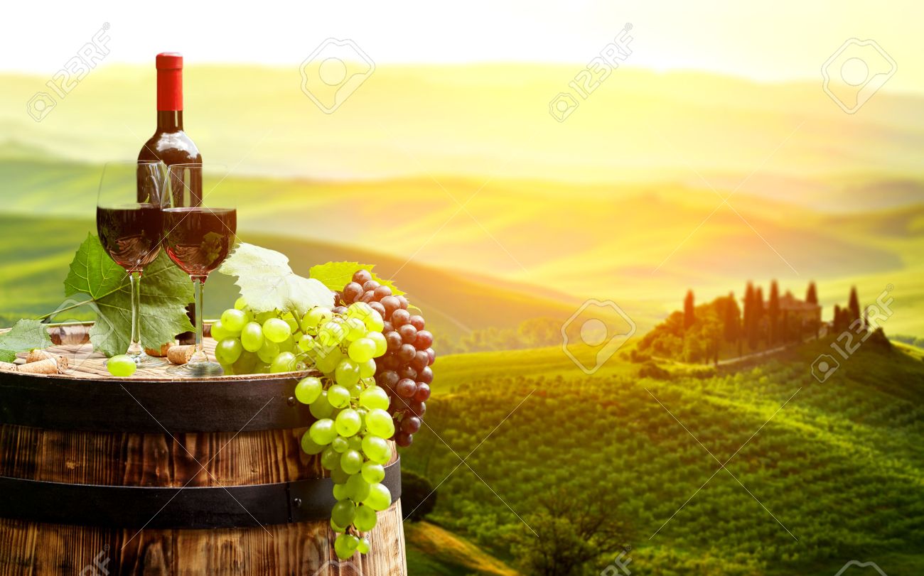 Red wine with barrel on vineyard in green Tuscany, Italy - 51590570 Red wine with barrel on vineyard in green Tuscany, Italy - 51590570