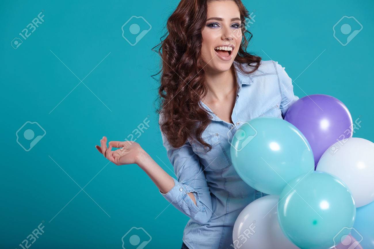 Young pretty woman with colored balloons - 53523334 Young pretty woman with colored balloons - 53523334