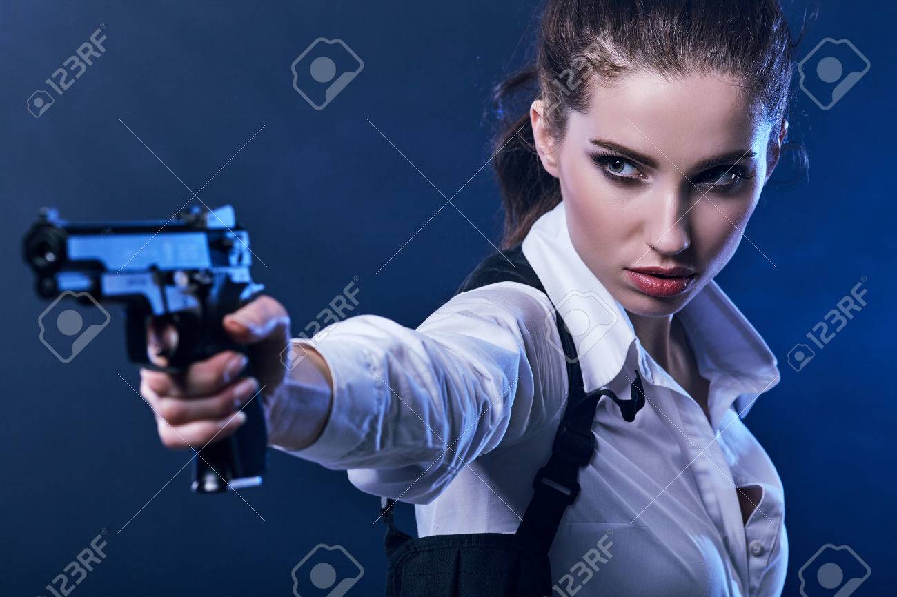 beautiful girl holding gun . smoke background - 55865065 beautiful girl holding gun . smoke background - 55865065