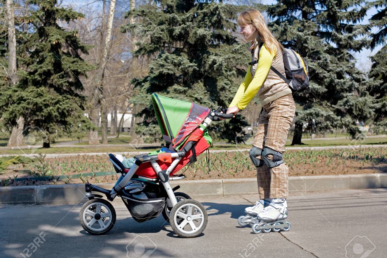 Young Mother On Roller Skates With Baby Carriage Stock Photo Picture And Royalty Free Image Image