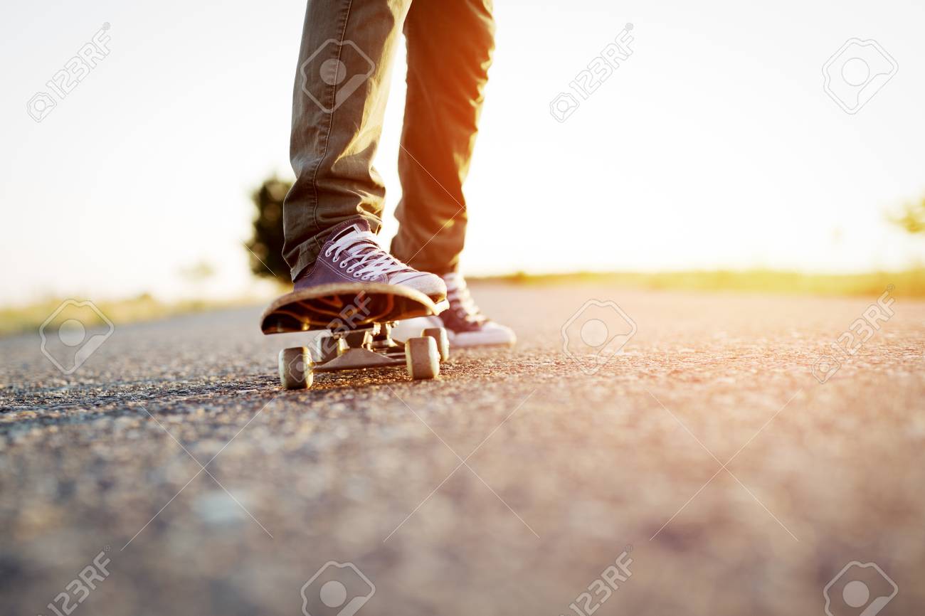 Sunlight over Legs of Person on Skateboard · Free Stock Photo