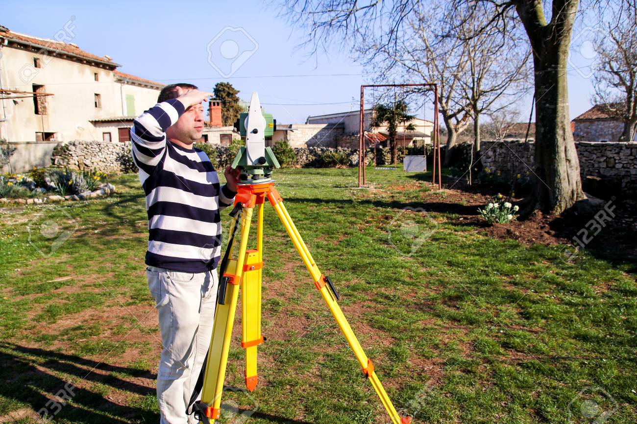 man using of total station guy surveyor at work survey instrument survey instrument
