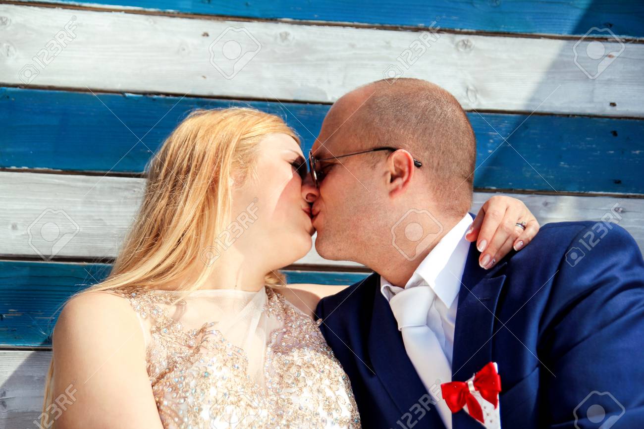 wedding wedding couple kissing beside the blue white wall house