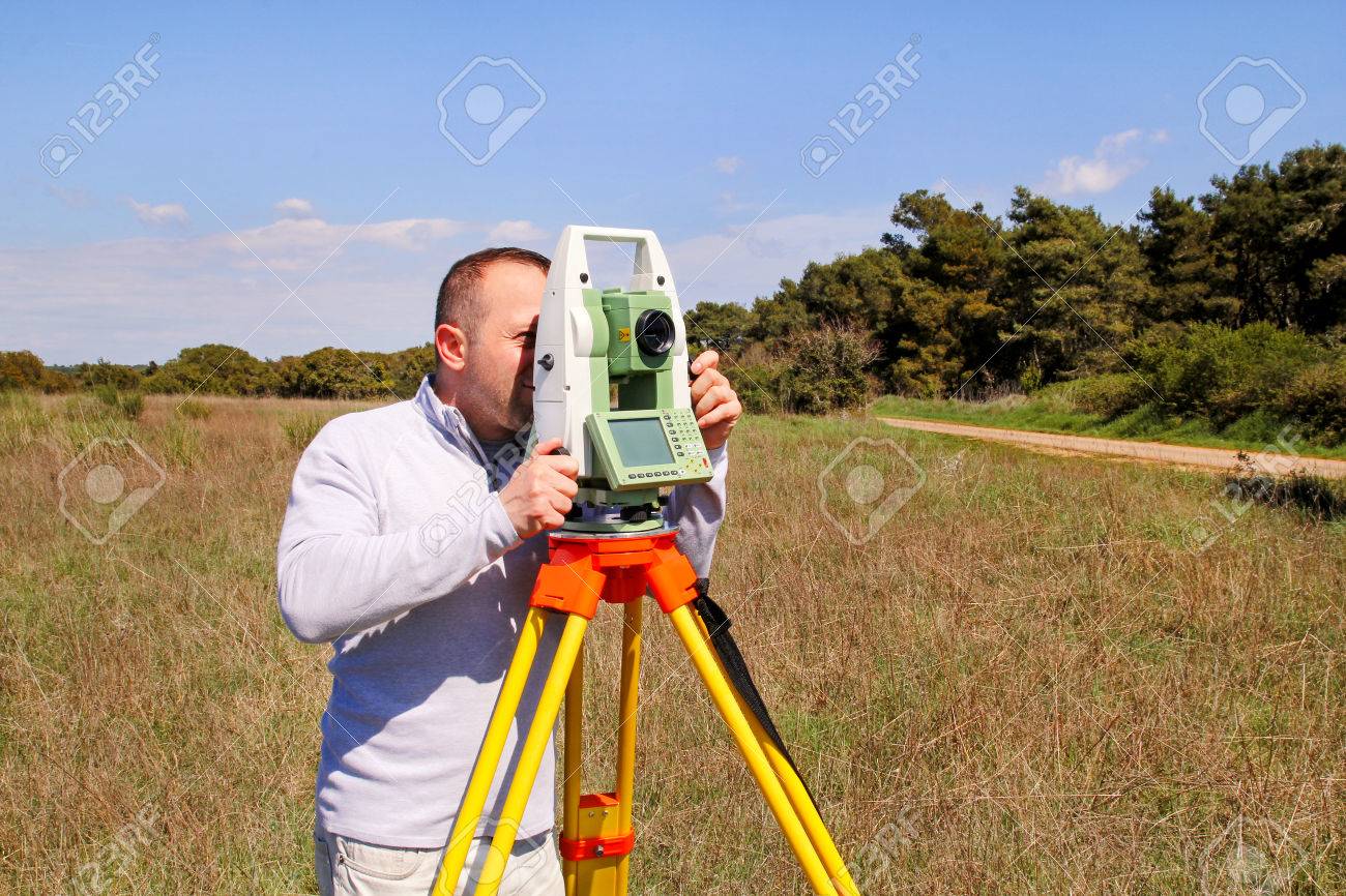 man using of total station guy surveyor at work survey instrument survey instrument