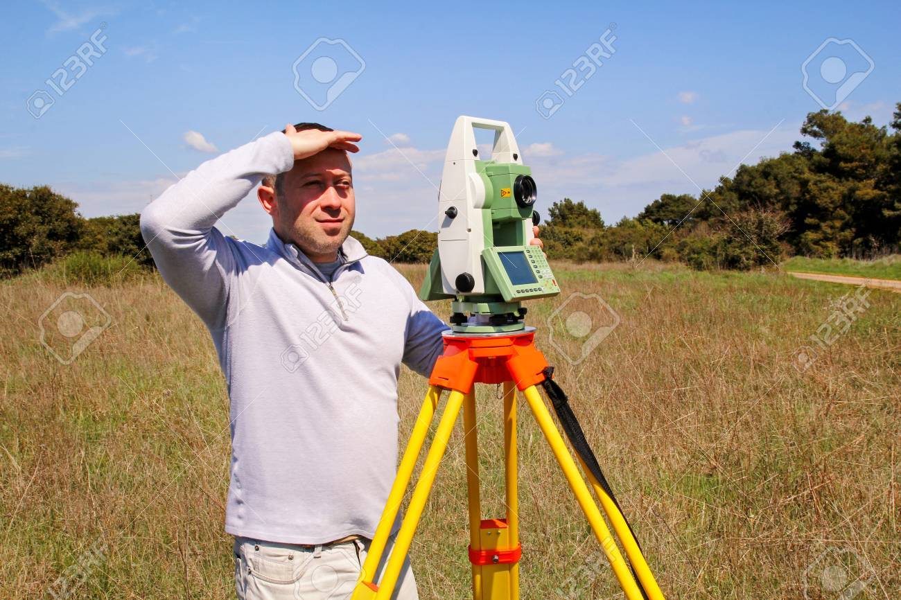 man using of total station guy surveyor at work survey instrument survey instrument